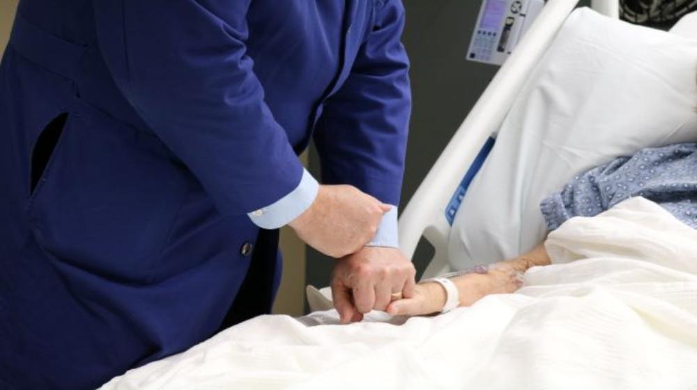 A chaplain visiting with a patient.